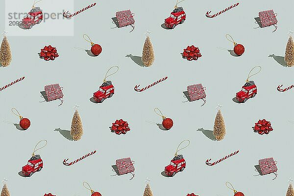 Gray green background pattern with Christmas  New Year symbol attribute objects and symbolic items concept. Small red English taxi car toy with ribbon  pink little gift box present.