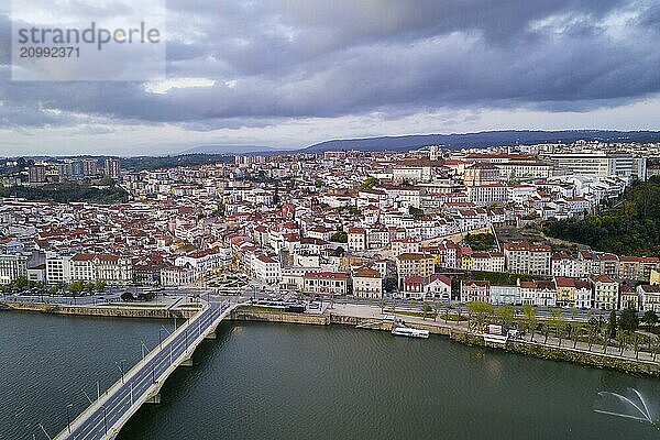 Coimbra drone aerial city view at sunset with Mondego river and beautiful historic buildings  in Portugal