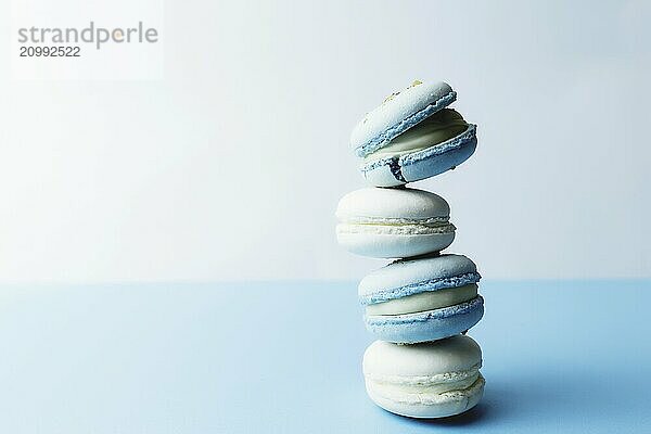 White and blue macaroons on the table  macaroons on white blue background.