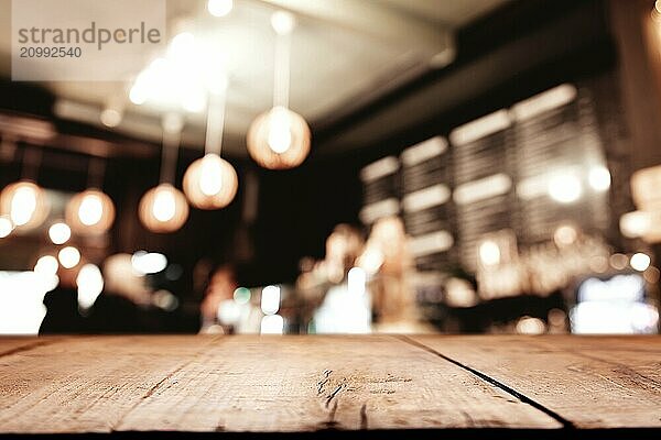 Empty blank wooden old deck table in front of abstract blurred festive background in bar  cafe  pub or restaurant with light spots and bokeh for product montage display of product. Copy space area