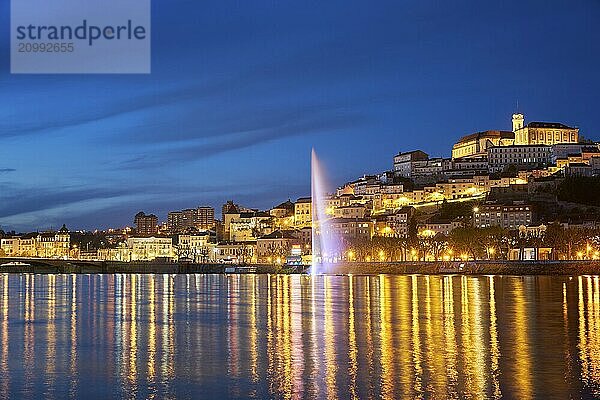 Coimbra city view at night with Mondego river and beautiful historic buildings  in Portugal