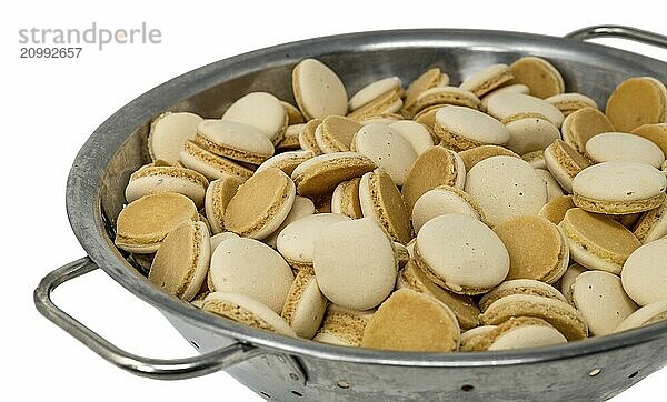 Home-baked aniseed Christmas biscuits in a metal bowl cropped on white