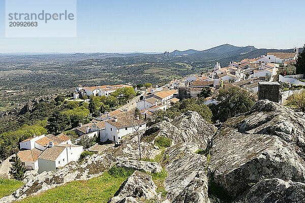 View of Marvao village with beautiful houses and church with rocky landscape mountains behind