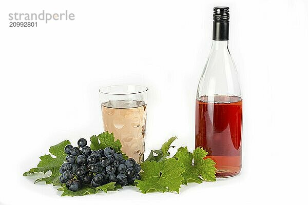 Rose wine with red Dornfelder grapes and vine leaves on white