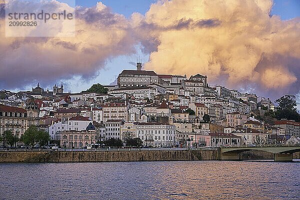 Coimbra city view at sunset with Mondego river and beautiful historic buildings  in Portugal