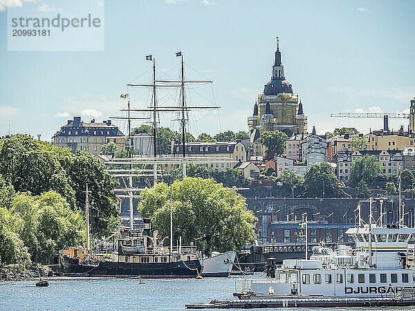 Urban scene with several ships on the water and buildings in the background  stockholm  baltic sea  sweden  scandinavia