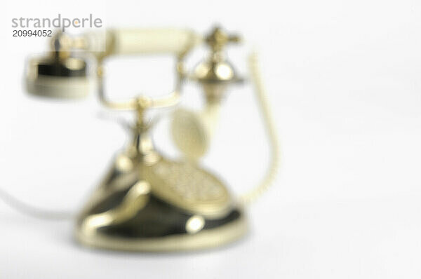 Out of focus telephone isolated on white background