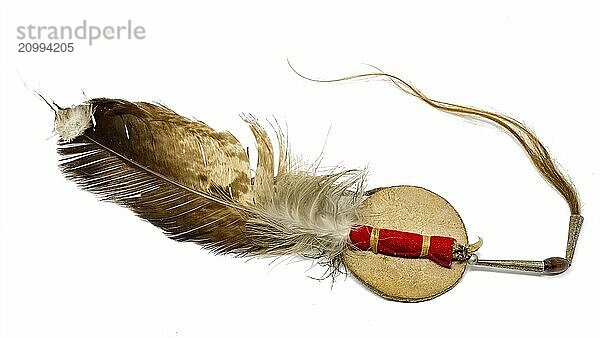 Eagle feather with horsehair as Native American hair ornament cut out on white