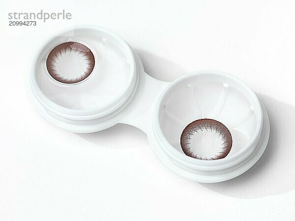 Closeup of circle cosmetic contact lenses in a container isolated on white background