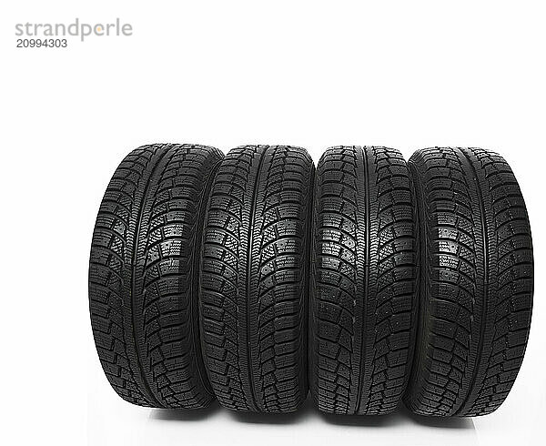 Set of four winter tires isolated on white background