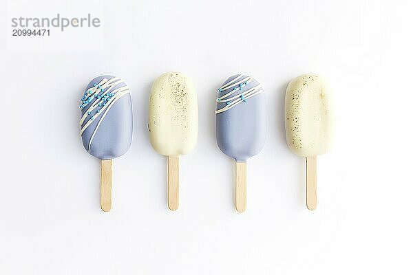 Blue and white cookie ice creams on a stick on white background.