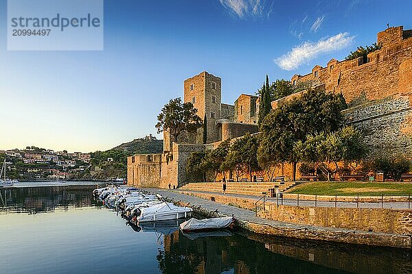 Medieval castle and boats at Collioure city at sunrise at Occitanie in France