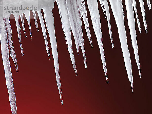 Melting icicles isolated on hot red background