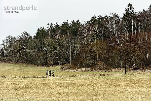 Small group of people walking across a field