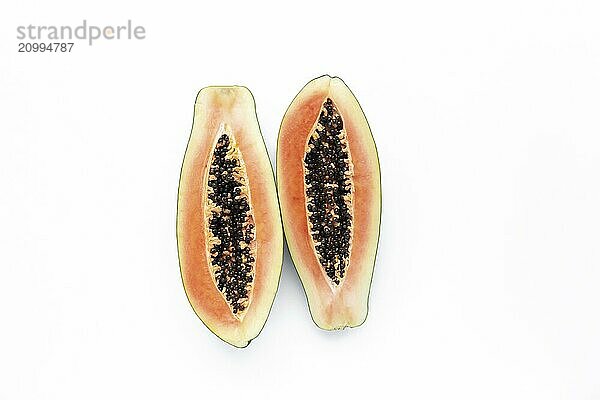 Isolated two halves of papaya fresh tropical fruit on white background.