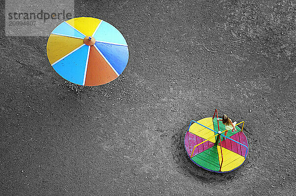 Stock photo of a Little girl on an empty playground Aerial view