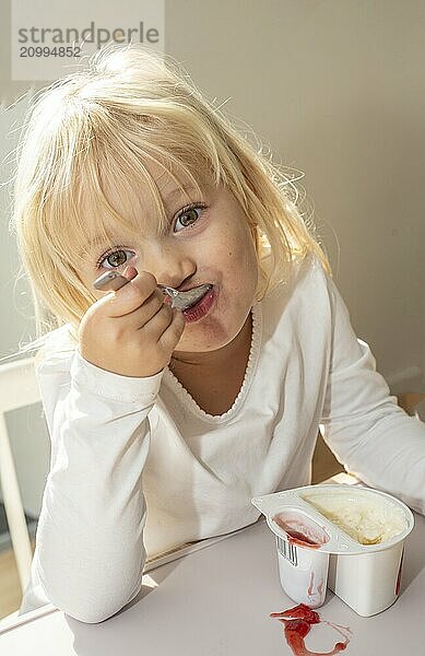 Portrait of blonde girl  3 years old  having lunch in Ystad  Skåne County  Sweden  Scandinavia  Europe