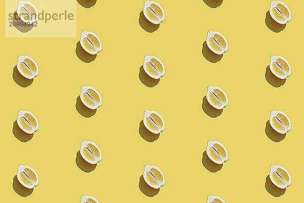 Conceptual pattern with halves of lemon collection with shadow on yellow background. Healthy eating  travel or vacation concept