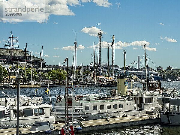 Harbour with a lot of boats  some buildings and a blue sky in the background  stockholm  baltic sea  sweden  scandinavia