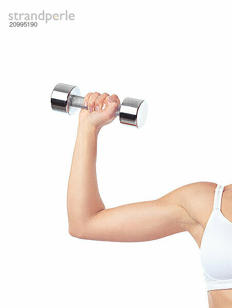 Young woman exercising with weight. Closeup of an arm with a dumbbell isolated on white background