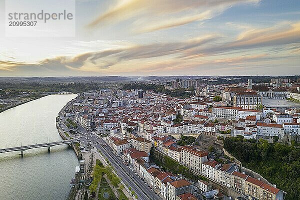 Coimbra drone aerial city view at sunset with Mondego river and beautiful historic buildings  in Portugal