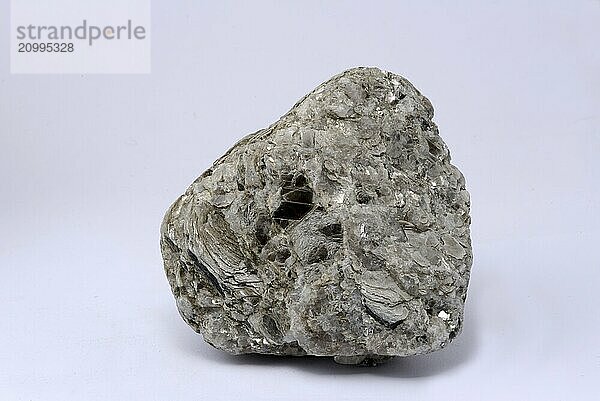 A well weathered specimen of iron pyrites on a white background