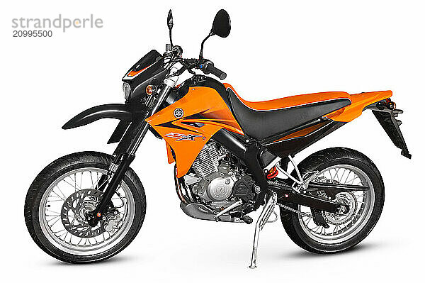 Orange Yamaha XT 125 X 2006 Super motard on and off-road racing motorcycle with four-stroke engine isolated with a clipping path on white background