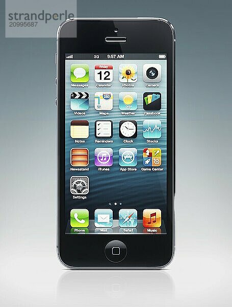 Apple iPhone 5 black smartphone with desktop icons on its display isolated on blue background with clipping path