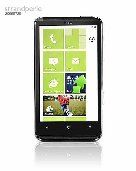 Windows 7 phone. HTC HD7 smartphone with desktop tiles on its display isolated with clipping path on white background. High quality photo