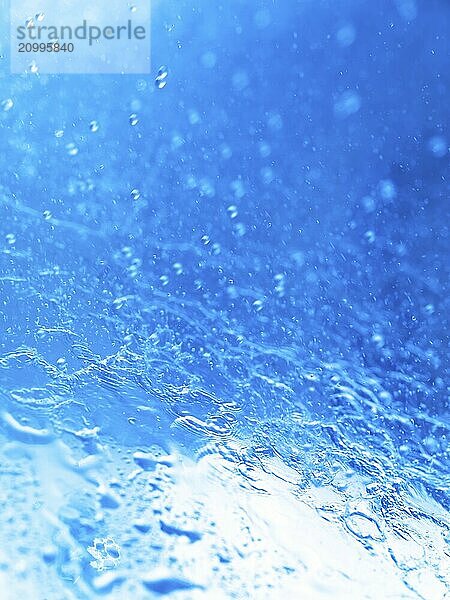 Closeup of splashing water abstract blue background texture