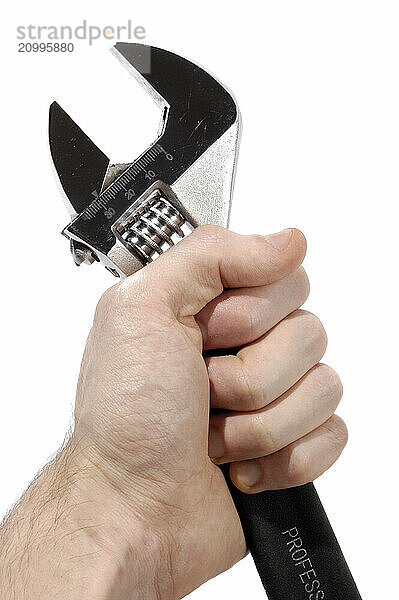 Hand with an adjustable spanner wrench closeup Isolated on white