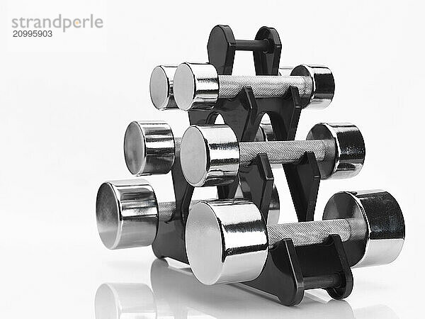 Shiny chrome dumbbells metal exercise weights isolated on white background