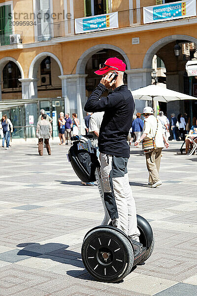 Man talking on the phone on his Segway