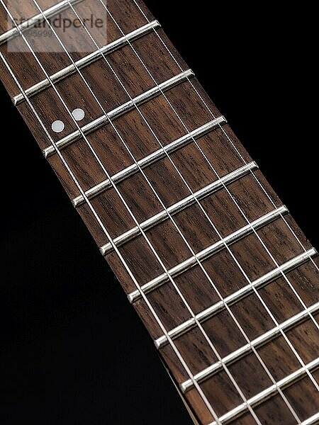 Closeup of electric guitar neck fretboard and strings