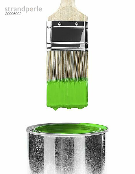 Painting brush dipped in can of green paint isolated on white background