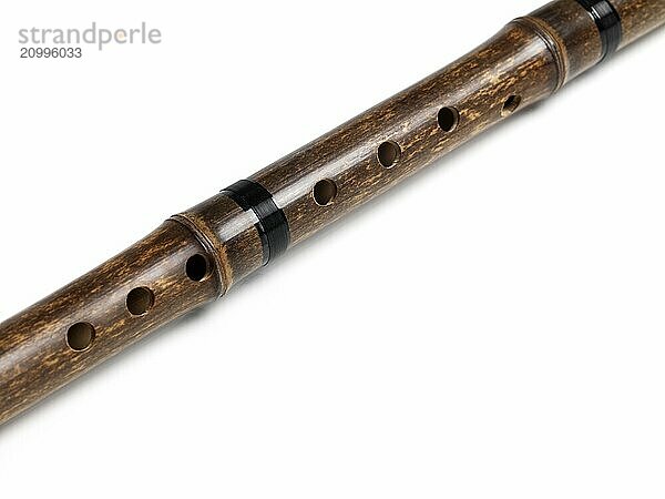 Xiao Chinese end-blown vertical bamboo flute closeup of air holes isolated on white background