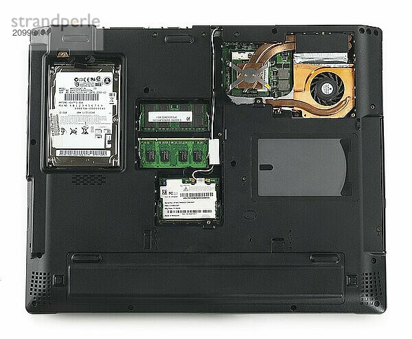 Laptop computer bottom side with back panels removed showing HDD  memory  processor and WiFi module isolated on white background