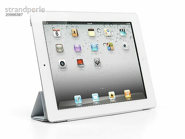 Apple iPad 2 tablet computer with smart cover folded as a stand. Isolated with clipping path on white background