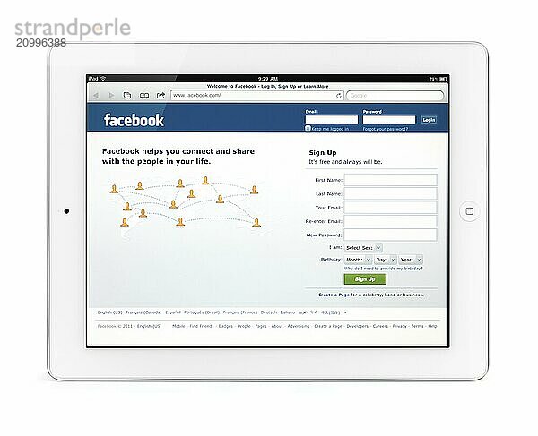 Apple iPad 2 tablet computer with Facebook social networking web site front page on its display. Isolated with clipping path on white background