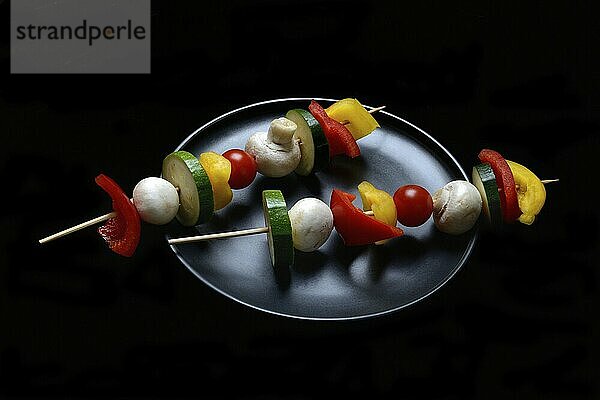 Colourful vegetable skewers on a plate  barbecue skewers