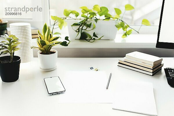 Smartphone on white table  work from home  office stuff.