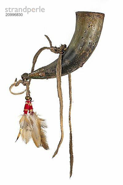 Old powder horn of the North American Indians made of horn decorated with deerskin and feathers painted on white