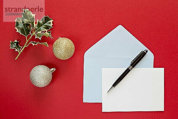 Christmas letter and pen over a red background with decorations