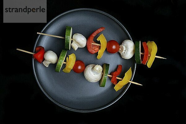 Colourful vegetable skewers on a plate  barbecue skewers