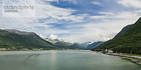 Panoramic view of Romsdalsfjorden and mountains from Andalsnes in Norway under a sunny sky