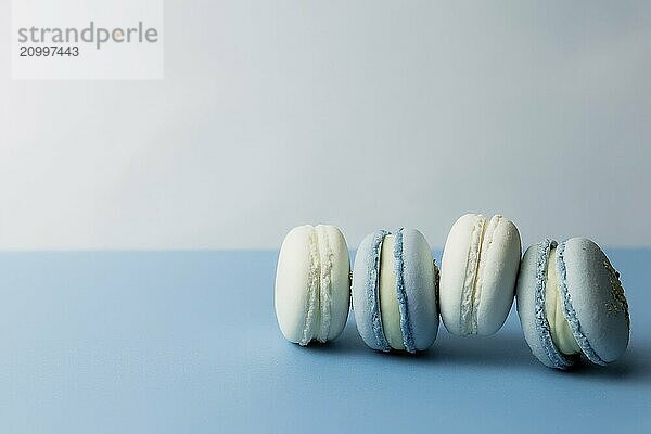 White and blue macaroons on the table  macaroons on blue background.