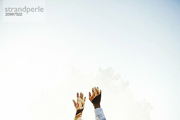 Wedding couple hands on the sky background.