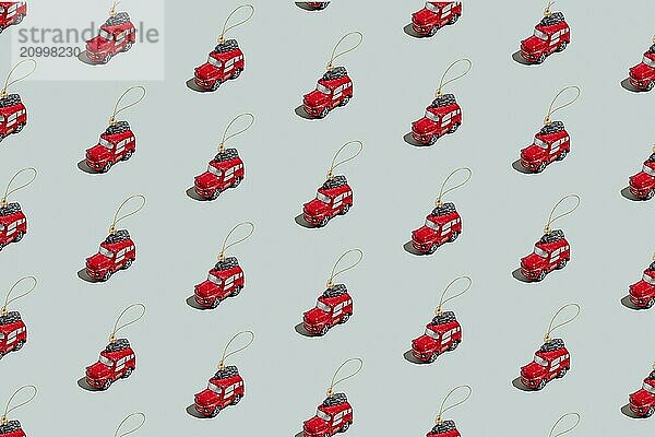 Gray green background pattern with Christmas or New Year symbol attribute objects and symbolic items concept. Small red English taxi car toy with ribbon  golden little toy fir tree.