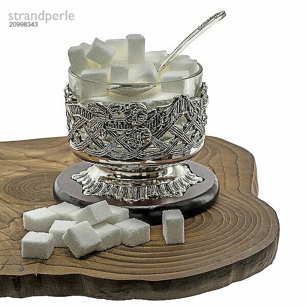 Silver metal sugar bowl with glass insert and spoon. Released on white