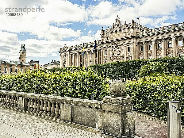 An impressive building with flags and baroque design  under a blue cloudy sky  stockholm  baltic sea  sweden  scandinavia